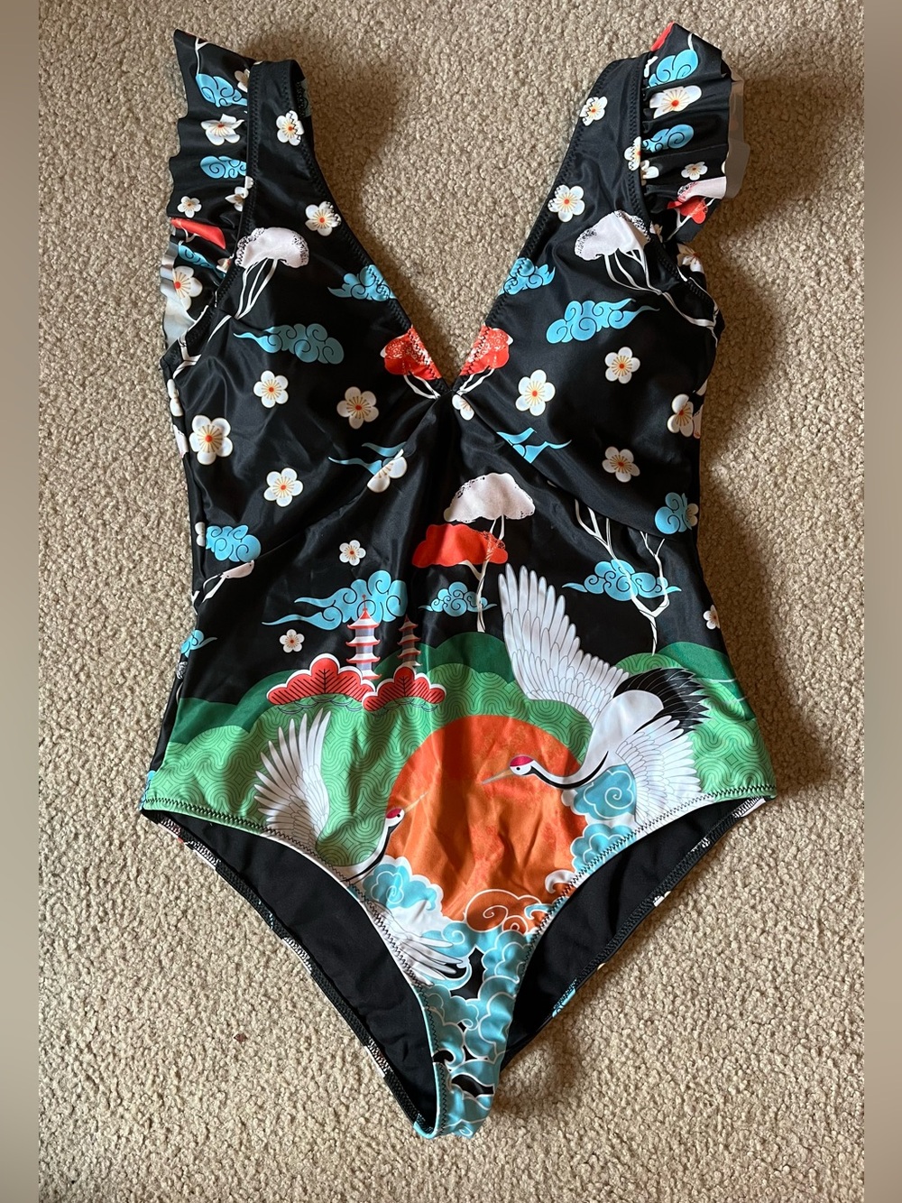 Averie women’s ones piece swimsuit. Deep plunge front and back. Ruffle sleeves.